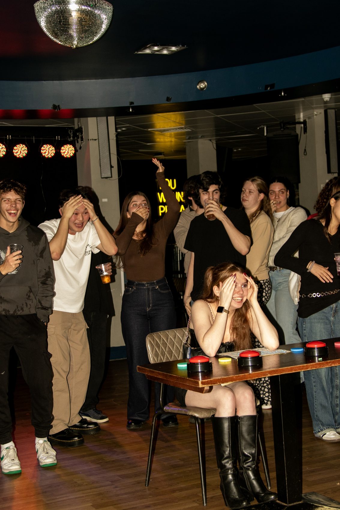 A player at the buzzers, hands on her head, as the crowd behind her reacts