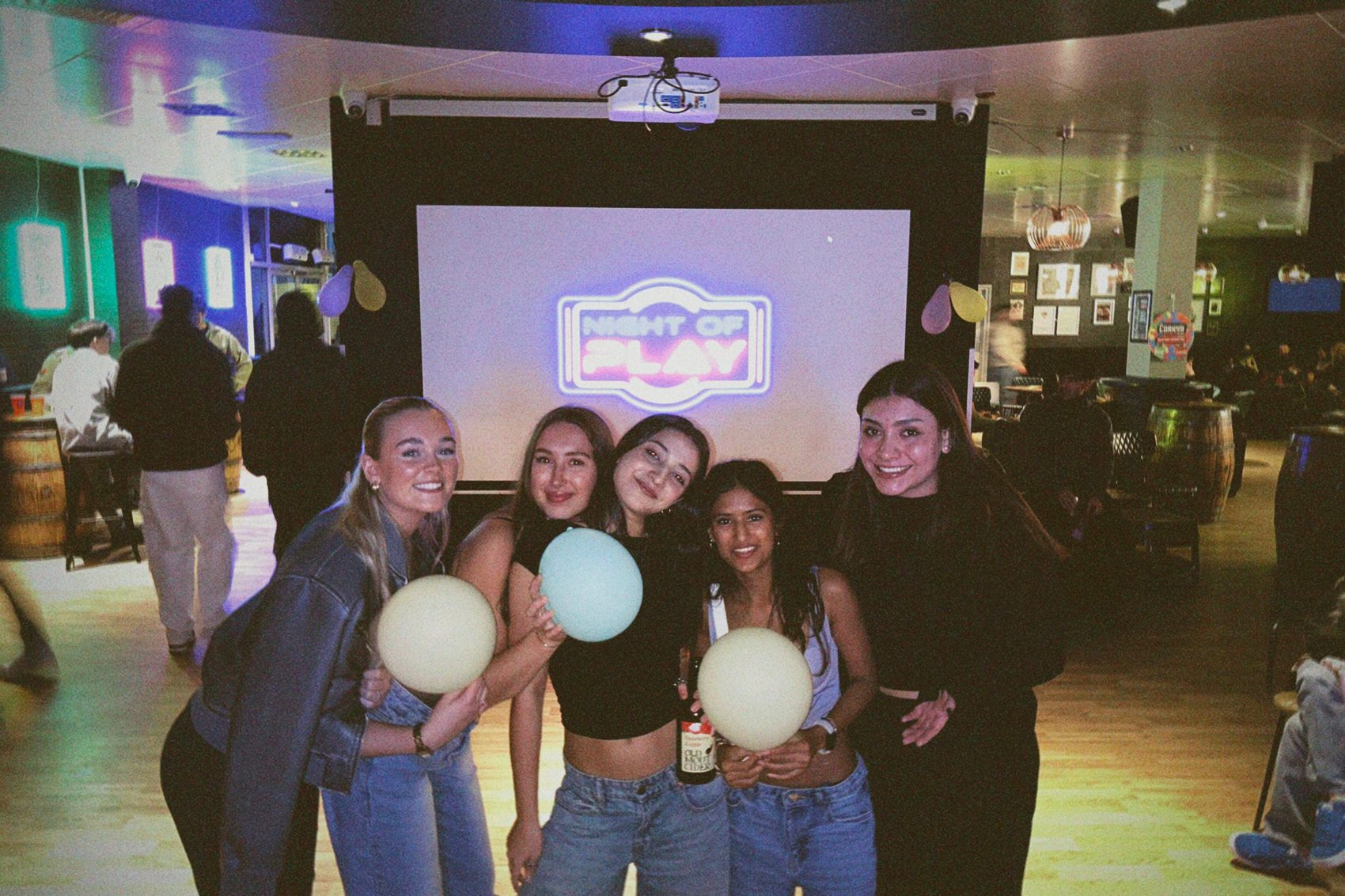 A team posing in front of the Night of Play screen